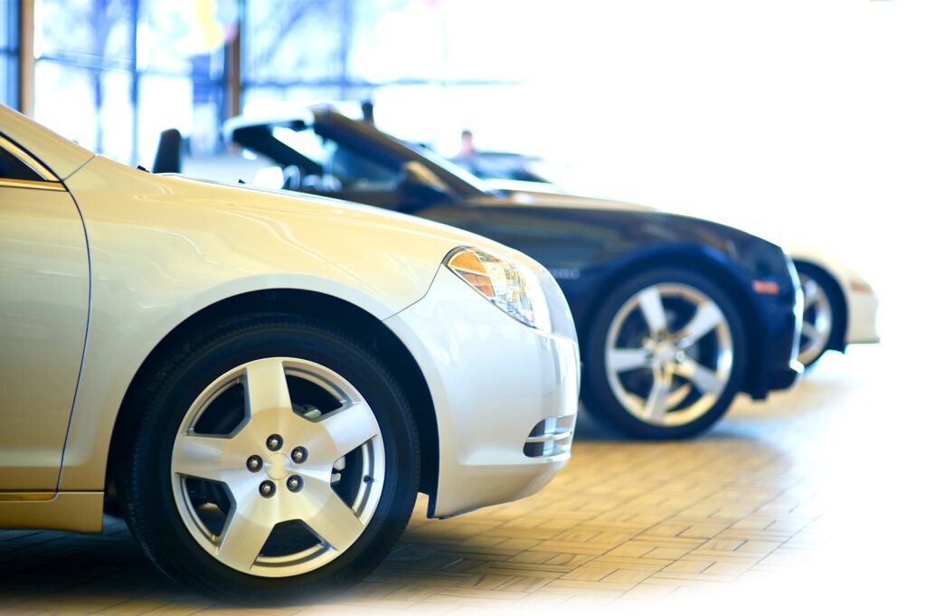 Dealership Showroom. Three Cars in the Showroom. Vehicles for Sale.