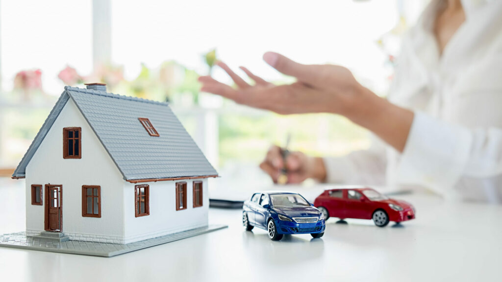 Car and House model with agent and customer discussing for contract to buy, get insurance or loan real estate or property background.