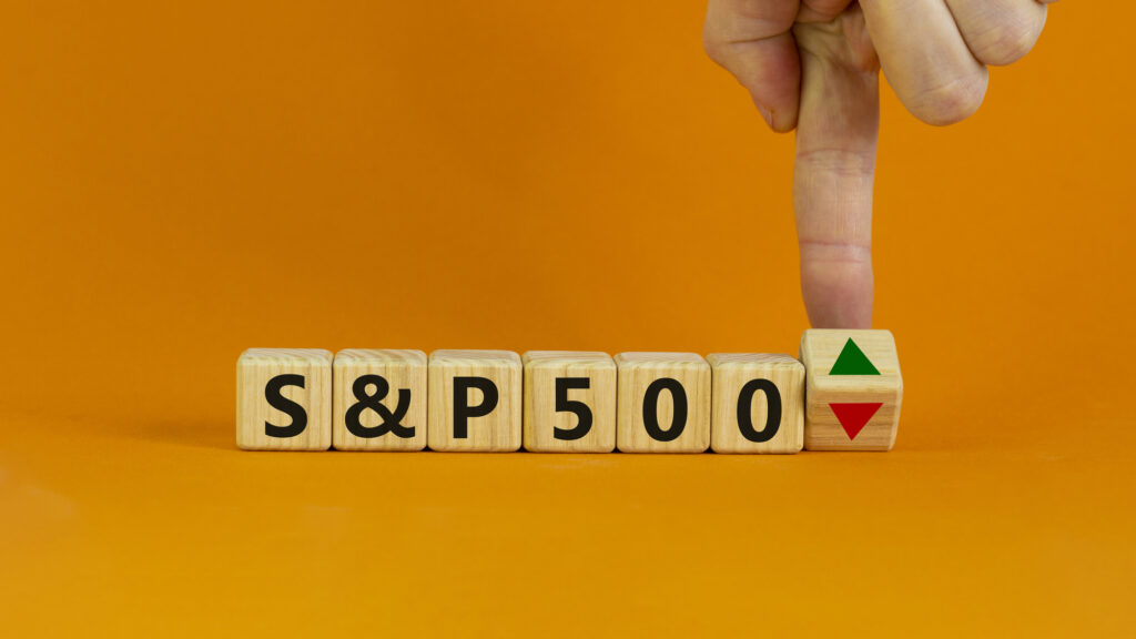 S and P 500 symbol. Businessman turn a cube and changes the direction of an arrow symbolizing that the S and P500 Index is changing the trend and goes up instead of down. Business, S and P500 concept.