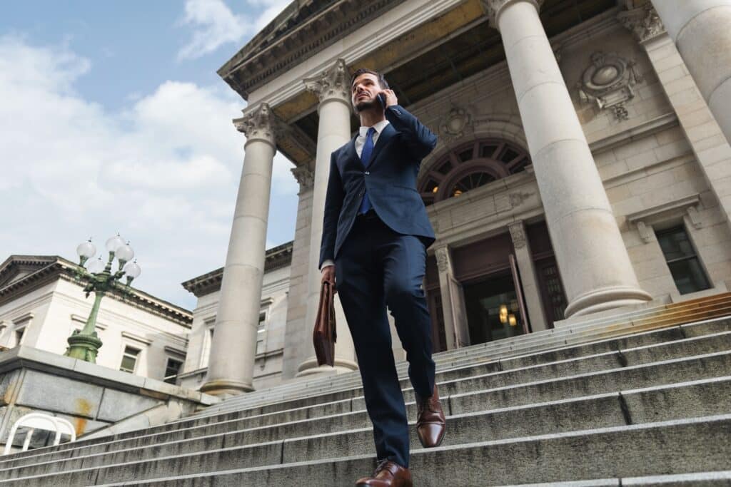 An investor use smartphone in front of the bank, business of finance and founder or banker