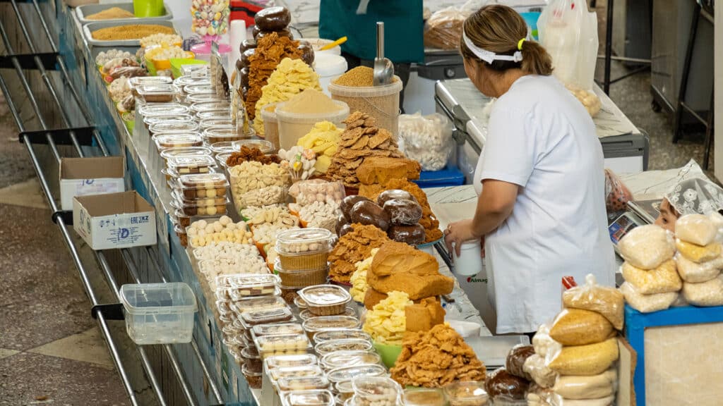 September 4, 2025, Almaty, Kazakhstan: Popular old market in Almaty city, Tourist place, market where locals and tourists buy goods. Buyers choose goods at the green bazaar.