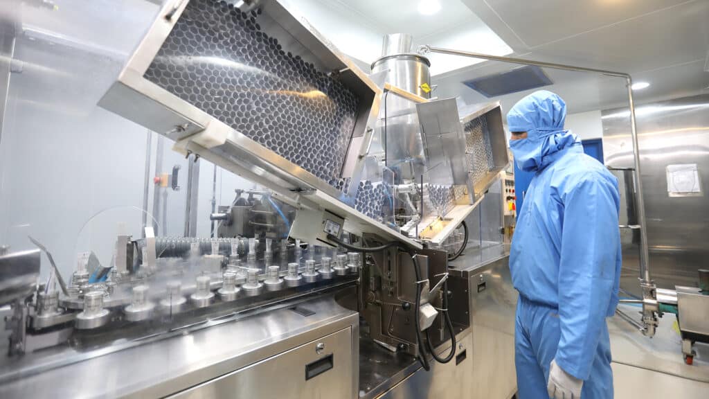 Pharmaceutical cream and ointment manufacturing process, medical or cosmetic paste production and automatic tube filling, sealing, packaging line in sterile factory with machinery and conveyor system