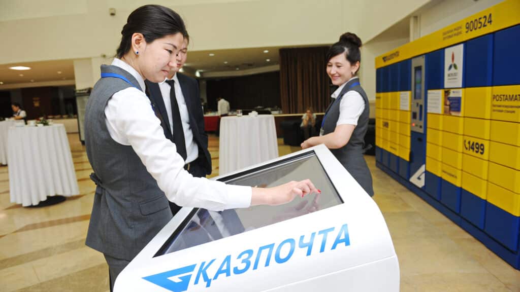 Almaty, Kazakhstan - 06.23.2016 : Kazpost employees help visitors with receiving parcels.
