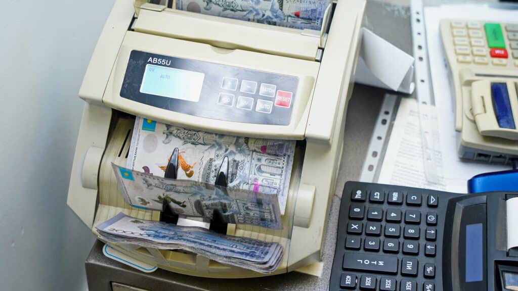 Almaty, Kazakhstan - 01.24.2025 : The banknotes of Kazakhstani tenge are recalculated in the counting machine.