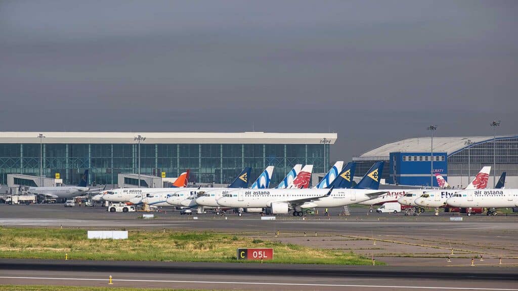 ALMATY, KAZAKHSTAN - MAY 14, 2025: Planes at Almaty airport, arrival and departure of flights, standby mode. International air transportation.