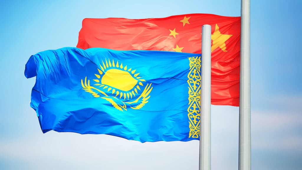 Chinese and Kazakhstan flags against the background of blue sky