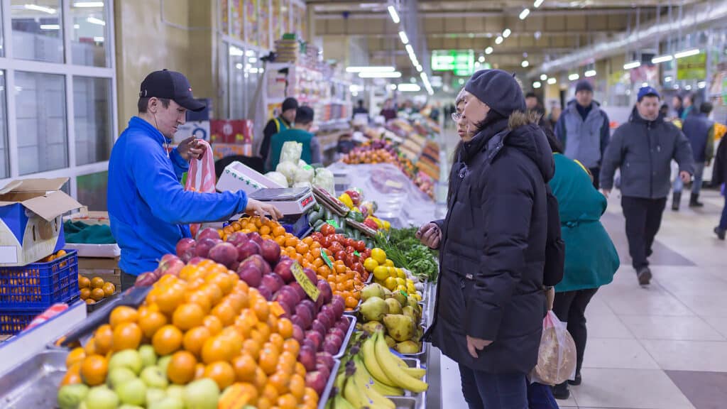 Astana, Kazakhstan, January 11, 2019: Asian people buying and selling tropical fruit