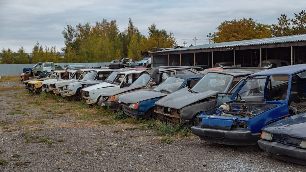 Old rusty cars in junkyard.