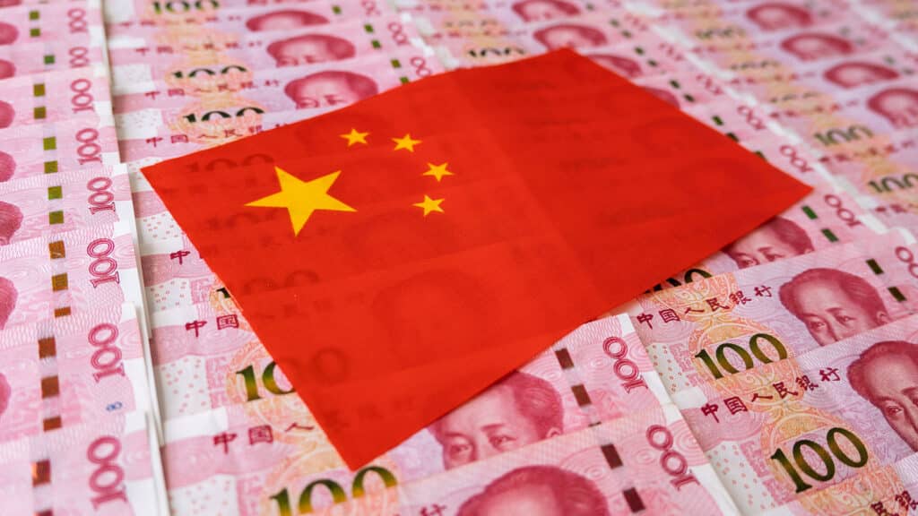 Money, currency of PBOC or people's bank of china. One hundred CNY Chinese yuan bill with a flag of China. 100 rmb or renminbi, depicts Beijing economy system, public banking policy and interest rate