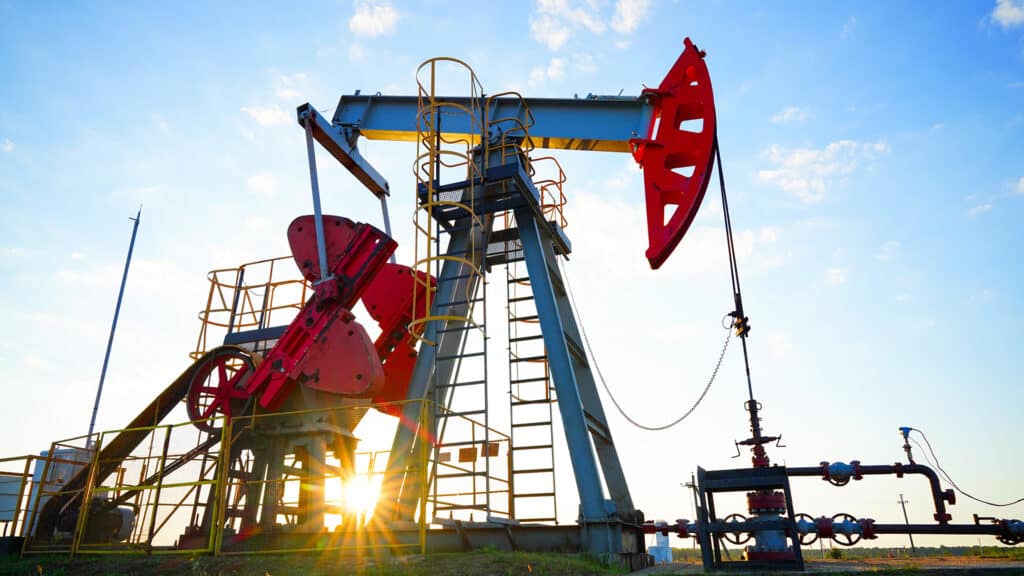 Pumpjack in oil well of oil field on sunset in Industrial crude area. Crude pump jack working on oil field. Pumpjack, Oil drill rig, drilling derrick in oilfield. Natural gas, Crude petroleum industry
