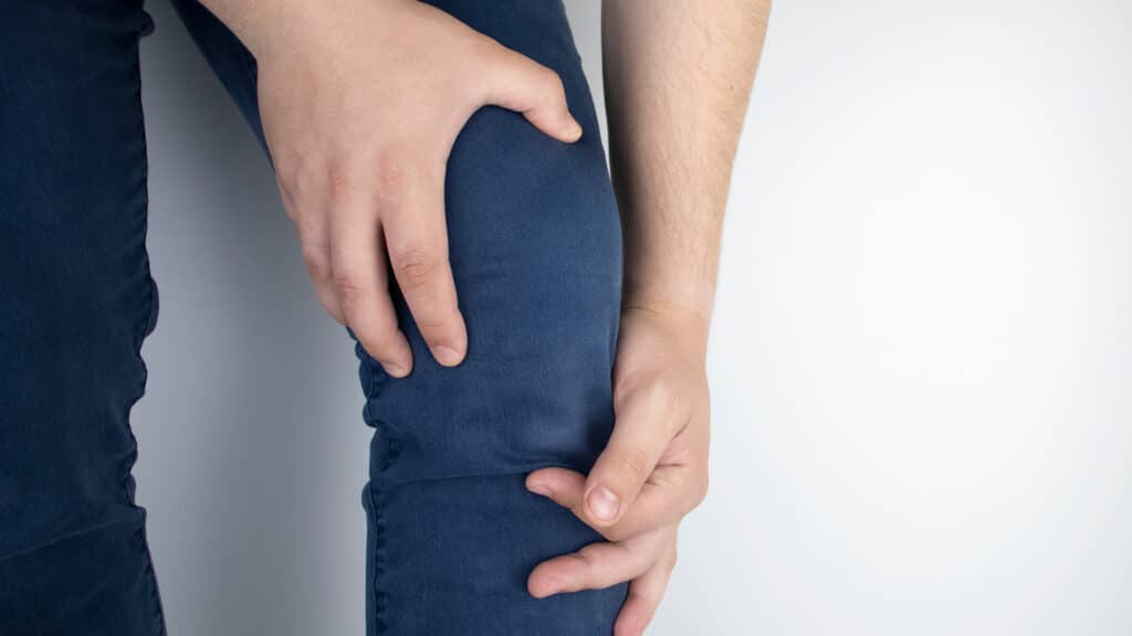 A man suffers from knee pain. Examination by an orthopedist and traumatologist. Redness and swelling of the legs, torn meniscus or knee bursitis