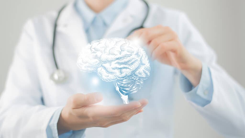 Female doctor holding virtual volumetric drawing of  Brain in hand. Handrawn human organ, copy space on right side, raw photo colors. Healthcare hospital service concept stock photo