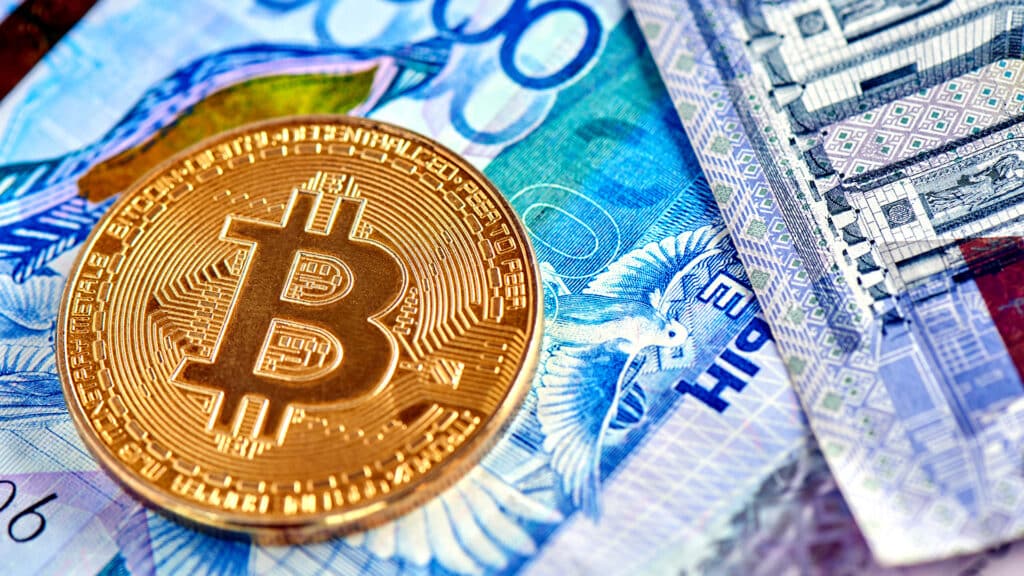 Kazakh tenge money and cryptocurrency Bitcoin close-up. Digital virtual internet currency investment concept