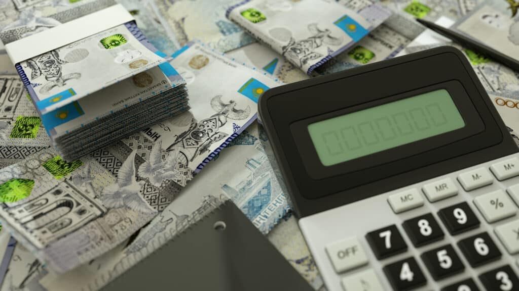 Kazakhstani Tenge notes spread out  with a calculator, pen and notebook. 3d rendering
