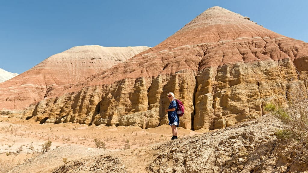 Tourist  hiking in Aktau Mountains. Altyn-Emel National Park. Kazakhstan. Asia. 19th August 2025.