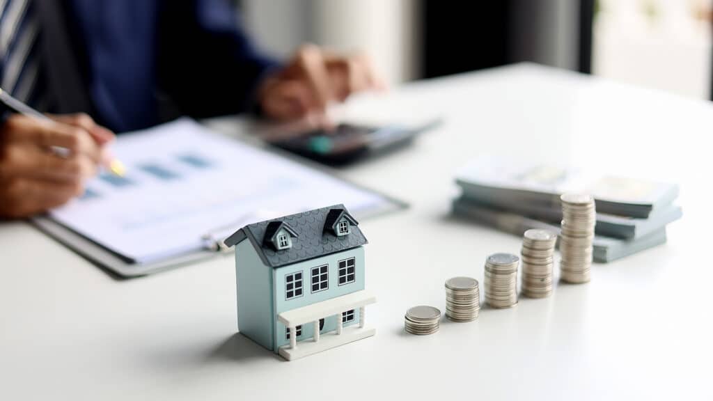 Investing in Real Estate, Real estate agent or investor calculating, planning, analyzing financial data for property investment. Themes of saving, investing, financial aspects of purchasing a home.