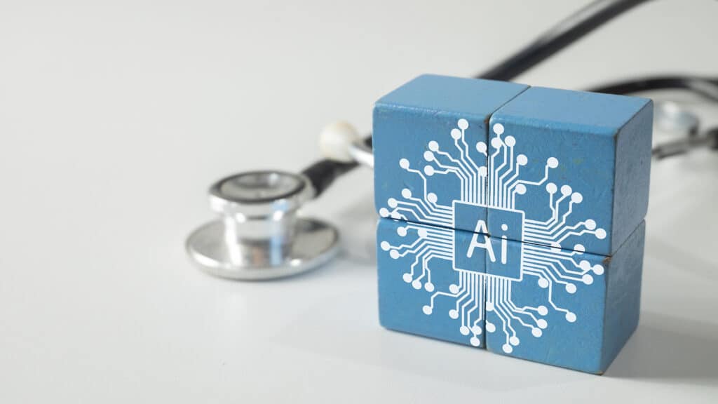 An AI icon on blue blocks with a stethoscope. A concept for Artificial Intelligence in healthcare, medical technology (MedTech), digital health, and the future of medicine. A symbol of innovation.