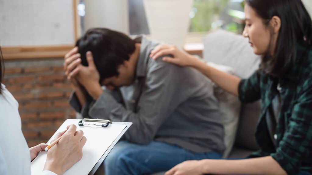 psychologist talking with married couple about depression of husband.