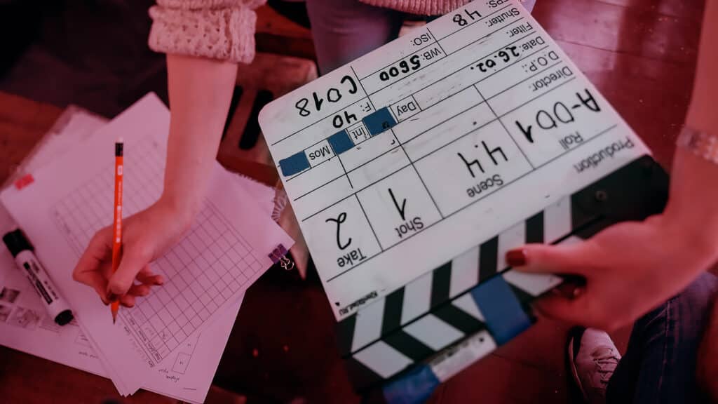 Assistant director with clapperboard on set. Close-up of firecrackers for filming a movie, advertising, TV series. Modern photography technique.