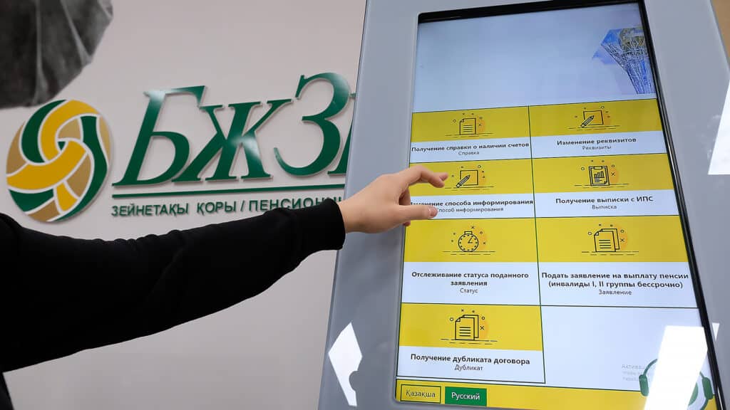 Almaty, Kazakhstan - 12.03.2020 : Visitors to the pension Fund use an electronic scoreboard to receive documents and certificates.