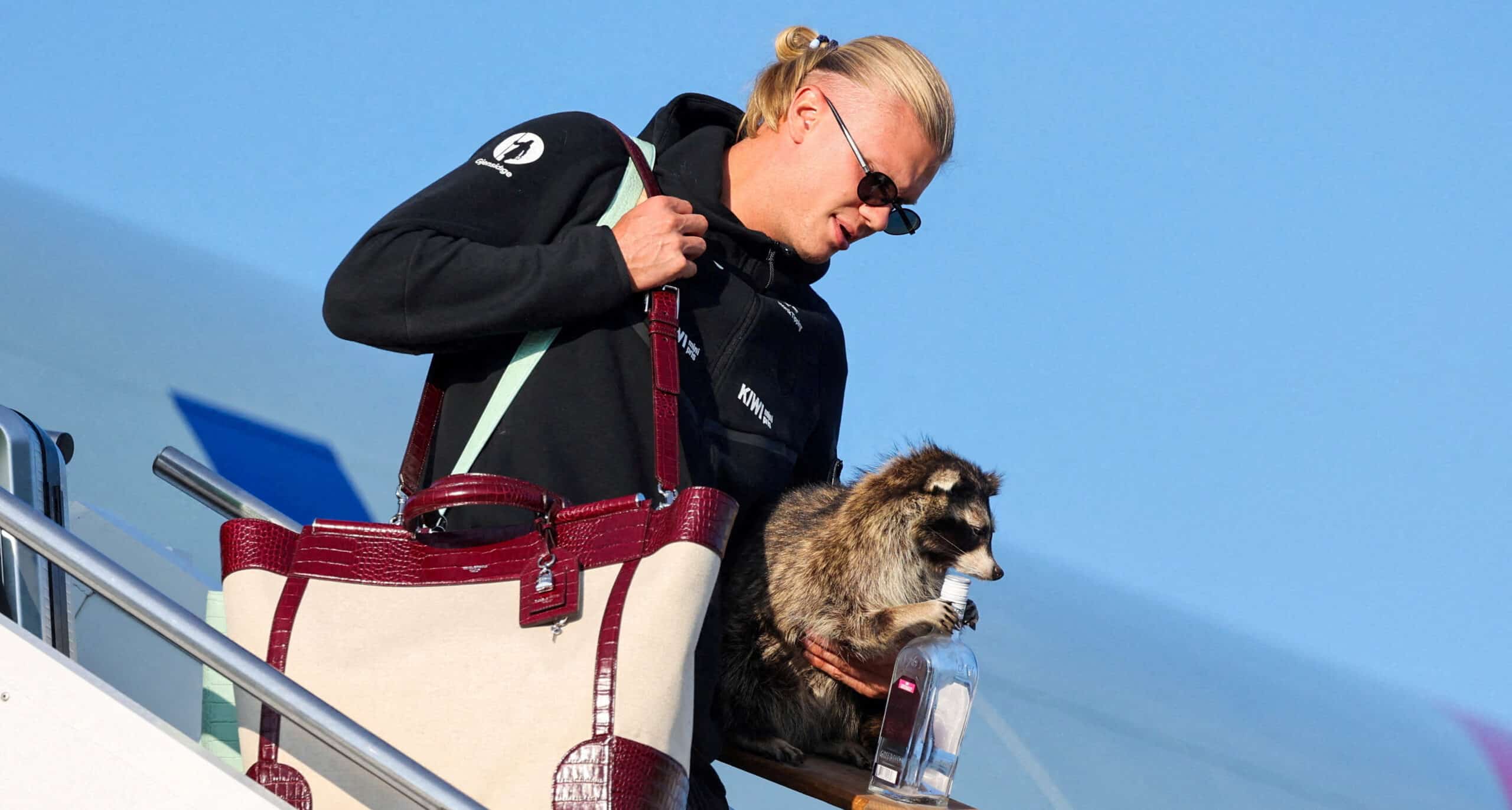 Erling Braut Haaland carries a stuffed raccoon as he gets off the plane after the national football team landed at Oslo Airport, in Gardermoen, Norway, July 13, 2026. Jan Langhaug /NTB/via REUTERS ATTENTION EDITORS - THIS IMAGE WAS PROVIDED BY A THIRD PARTY. NORWAY OUT. NO COMMERCIAL OR EDITORIAL SALES IN NORWAY. NO RESALES. NO ARCHIVES. TPX IMAGES OF THE DAY